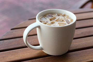 Cup of cold iced coffee on the table