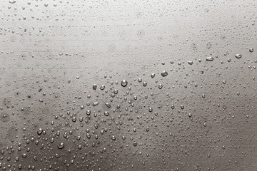 Silver surface with rain drops