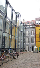 Fototapeta na wymiar View of the street with modern houses, yard with bikes, cloudy weather, Copenhagen, Denmark