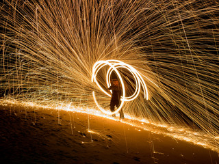 Obraz premium Amazing boy Fire Show at night on beach