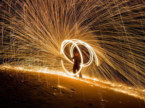 Amazing boy Fire Show at night on beach