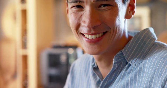 Smiling man at counter in restaurant 