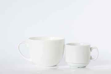 Two white porcelain mugs, different size and design, clean dishes mock up