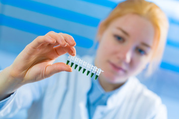 Woman student with pcr devices in medical laboratory