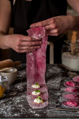 Female Making Beet Ravioli with Cheese