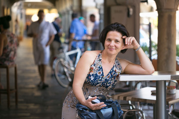 Beautiful woman in a street cafe at a table.