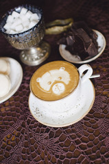 Cappuccino breakfast with chocolate and macaroons. 