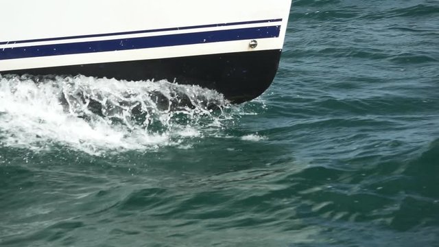 Sailboat prow sailing closeup in super slow motion