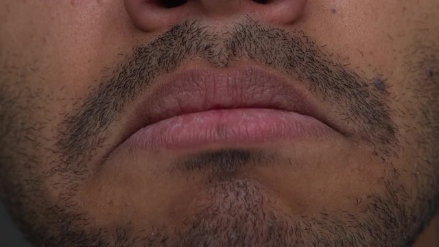 extreme closeup tan young man expressing cry with mouth HD50. Facial expressions, concept of emotions