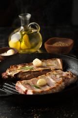 Grilled pork ribs with rosemary, spices and garlic in a frying pan grill