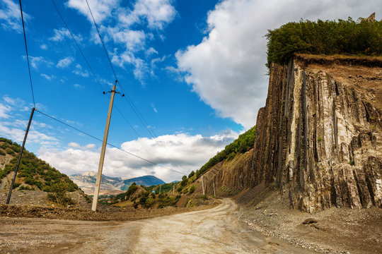 View of mountains Babadag and a muddy road along the river Girdimanchay Lahij yolu from the side in Lahic village, Azerbaijan