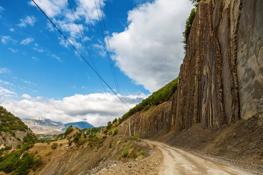 View of mountains Babadag and a muddy road along the river Girdimanchay Lahij yolu from the side in Lahic village, Azerbaijan