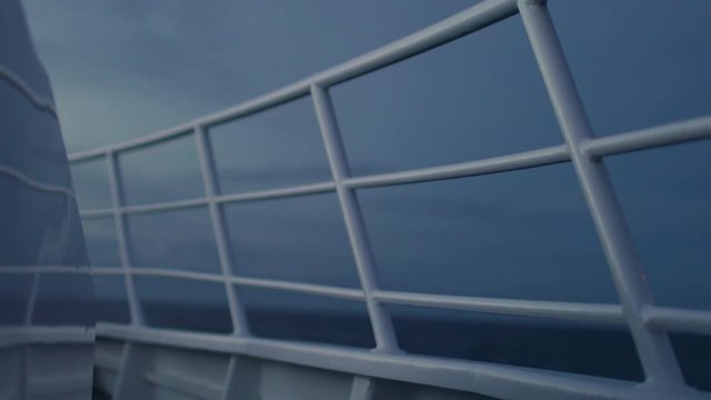 A medium shot of a boat's railings at night