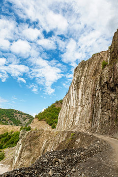 View of mountains Babadag and a muddy road along the river Girdimanchay Lahij yolu from the side in Lahic village, Azerbaijan