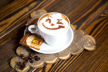 Smile face drawing on cappuccino art coffee. Concept of good day