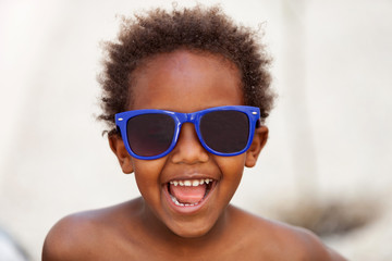 Funny Afro-American kid with blue sunglasses