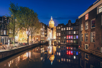 Fototapeta na wymiar Canals of Amsterdam at night in Netherlands. Amsterdam is the capital and most populous city of the Netherlands.