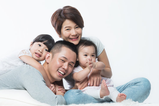 Young happy Asian family with kids