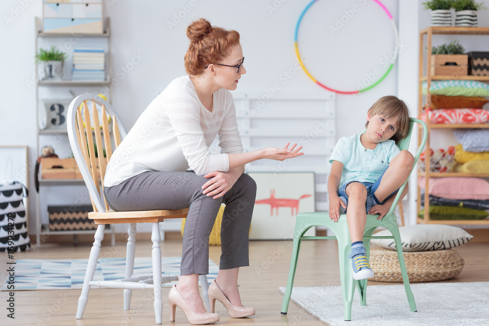 Poster counselor talking with worried boy