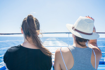 Two girls on ferry boat travelling - looking at, sunny, day, cruisiere, summer, holidays,...