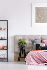 Stylish bedroom with black stool