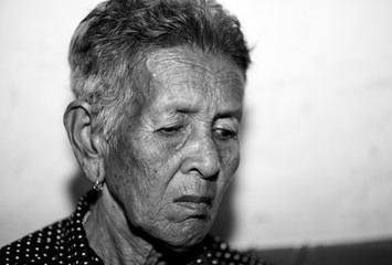 The old woman's felling lonely. ,she's senior woman in family and the elderly.