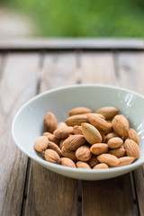 Almonds on outdoor wooden table 