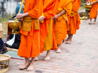 Alms giving ceremony in the early morning in Luang Prabang, Laos