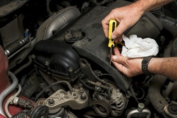 The mechanic fixes the vehicle's engine