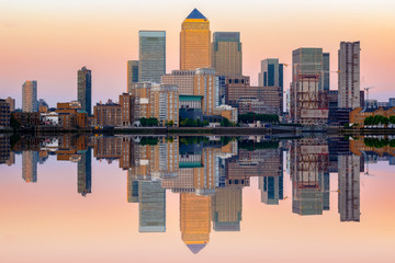 Pink sunset at Canary Wharf and its reflection from river Thames in London