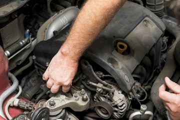 The mechanic fixes the vehicle's engine