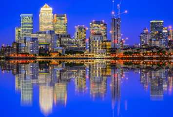 Fototapeta na wymiar Illuminated cityscape in Canary Wharf, a major business district in east London