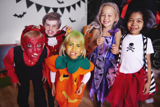 Kids posing  in halloween costume .
