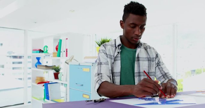 Male executive working over drafting table 