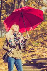 Woman walking in park with umbrella