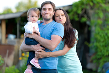 Family with baby girl walking outdoors