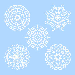 Vector set of five round snowflakes. Illustration of white mandalas on blue background