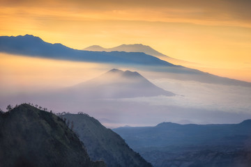 Fototapeta na wymiar Beautiful mountain and sea of clouds view during sunrise from viewpoint at Bromo Tengger Semeru National Park, East Java, Indonesia.