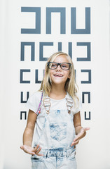concept vision testing. child girl with eyeglasses