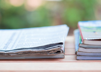 Daily newspaper with magazine on the wooden table.