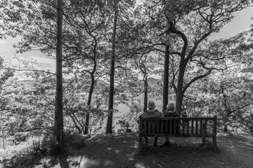 Old couple on bench, Derwent Water lake, Keswcik, UK- monochrome
