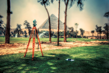 Total Station doing survey engineering works infront of pyramids