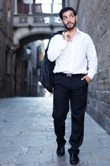 Obraz premium Man in formalwear walking along street