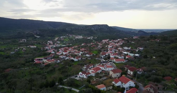 Flying over a village around Parque Natural de las Sierras de Aire y Candeeiros