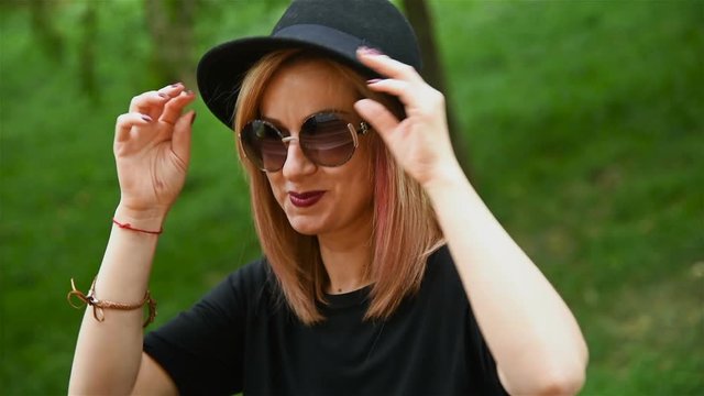 Happy Young Girl In Black Hat And Sunglasses. Slow Motion Effect