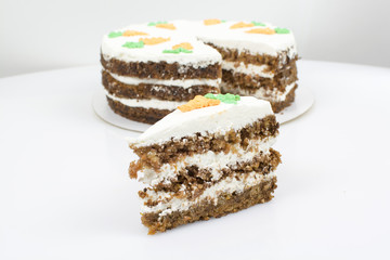 Piece of cake on the background of a whole cake
