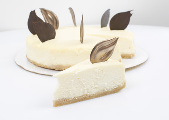 Piece of cake on the background of a whole cake