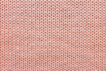 Obraz premium Openwork pattern on the knitted product with spokes made of woolen thread in pink, handmade