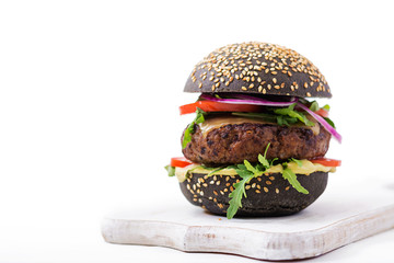 Black big sandwich -  black hamburger with juicy beef burger, cheese, tomato,  and red onion on...