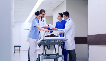 Obraz premium medics with woman on hospital gurney at emergency